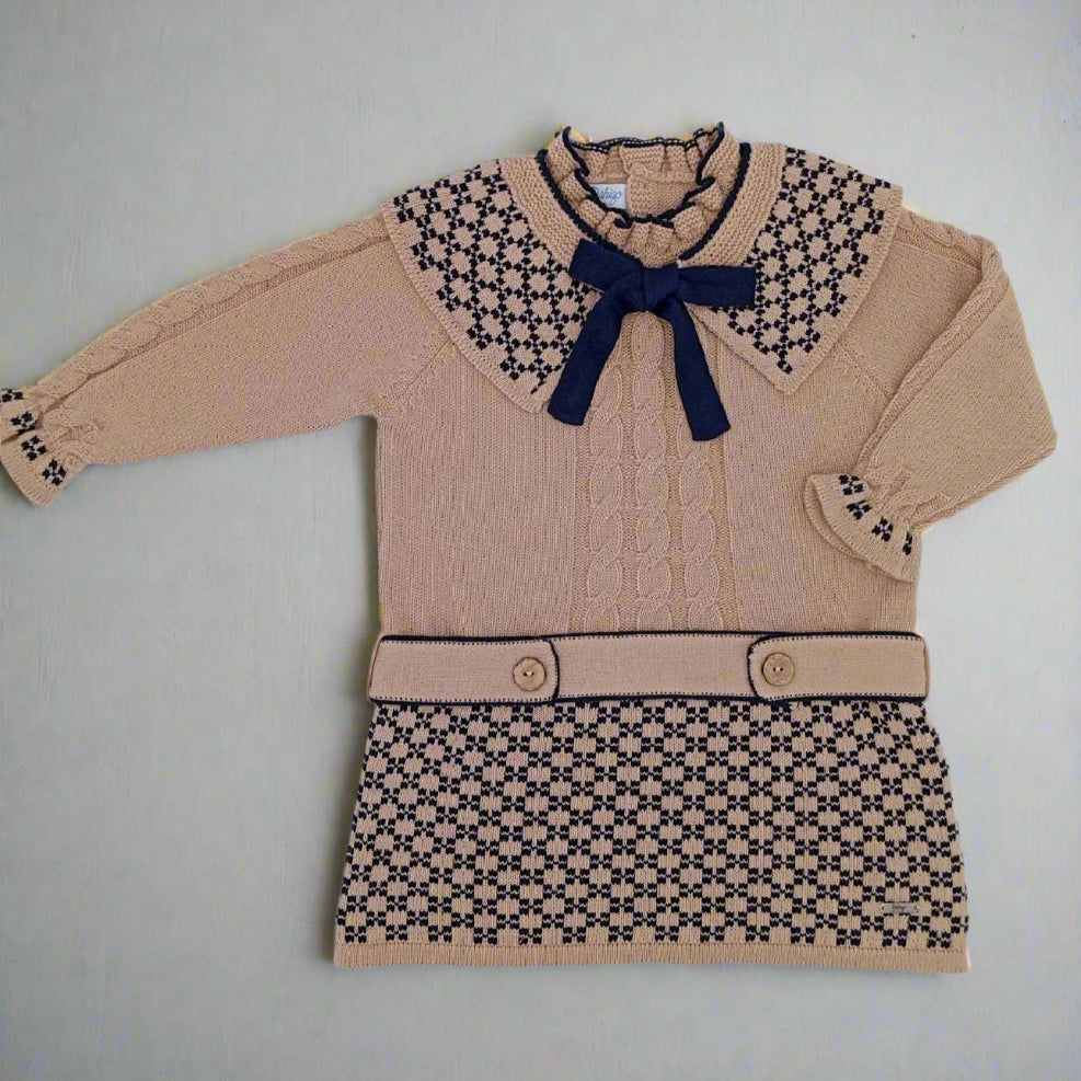 Beige sweater dress with patterned collar and skirt on a light gray background