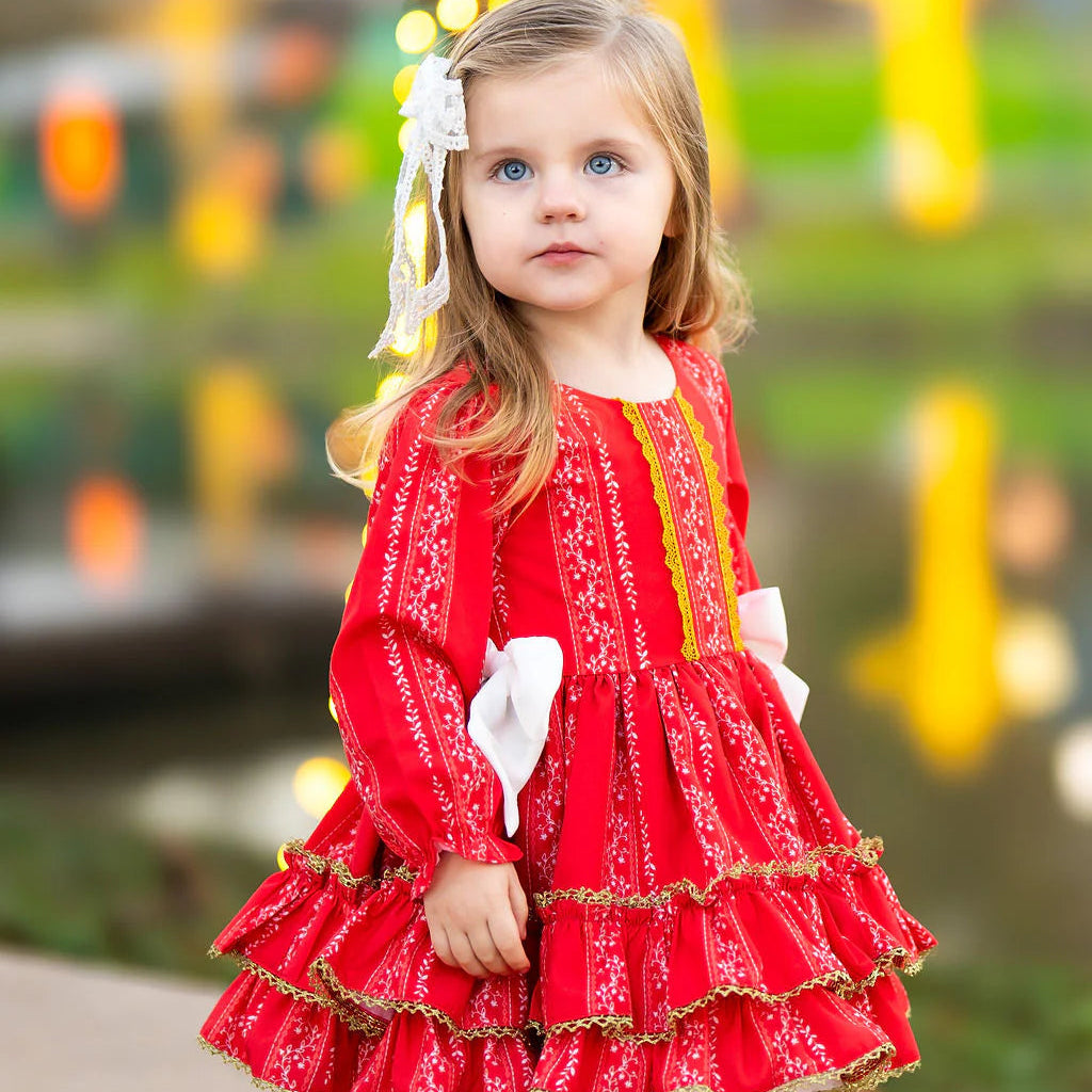 Young girl in a red dress with a blurred festive background