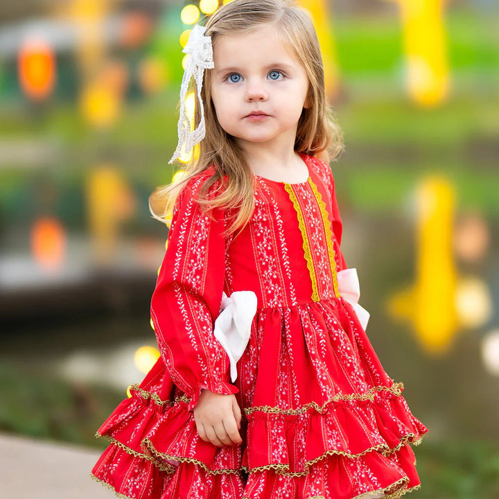 Young girl in a red dress with a blurred festive background
